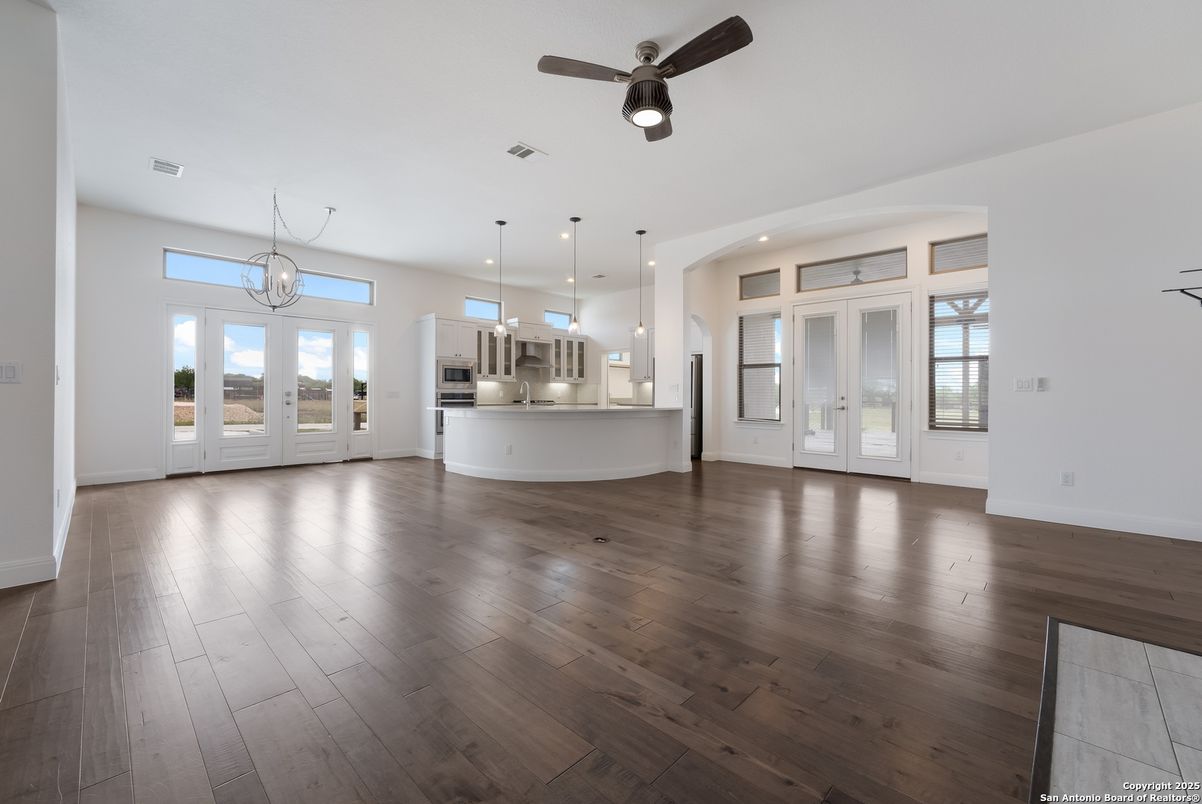 Chandelier, Empty room, Interior, Kitchen, Pendant Lights, Recessed Lighting, Stainless Steel Appliances, Wood Texture Flooring