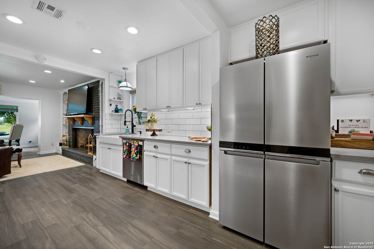 Fireplace, Interior, Kitchen, Recessed Lighting, Stainless Steel Appliances, Wood Texture Flooring