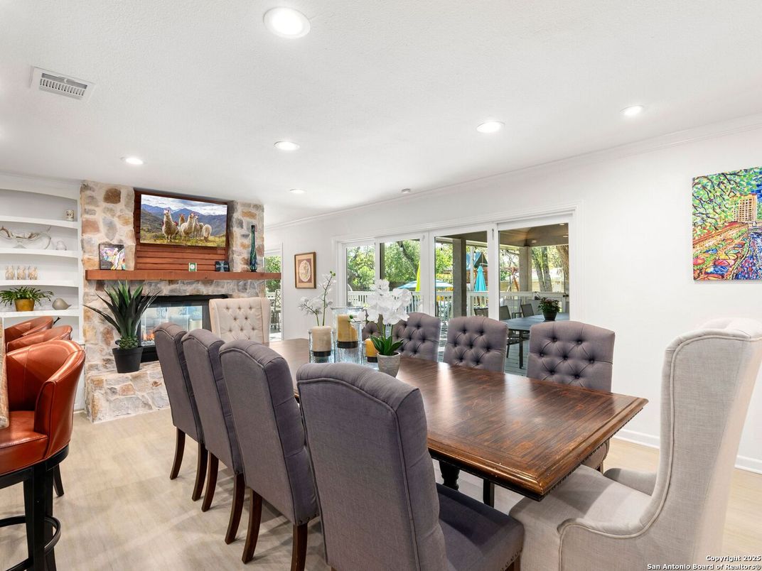 Dining room, Fireplace, Interior, Living room, Recessed Lighting, Stone Walls, Wood Texture Flooring