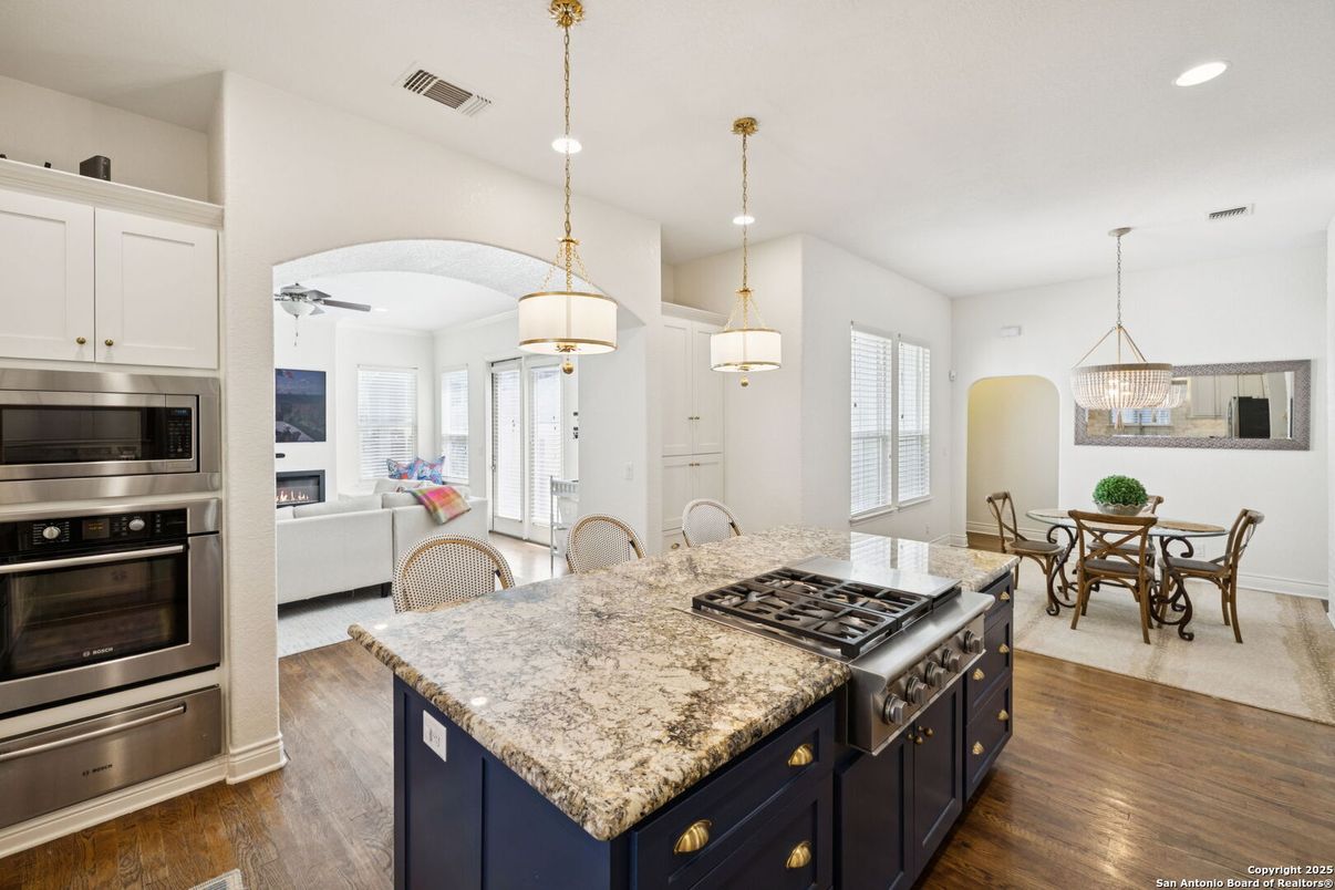 Dining room, Fireplace, Interior, Kitchen, Living room, Pendant Lights, Recessed Lighting, Stainless Steel Appliances, Wood Texture Flooring