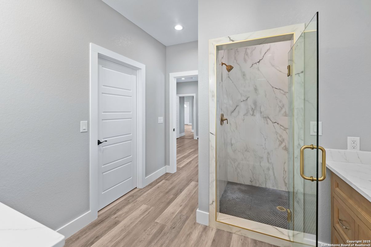 Bathroom, Glass Shower, Interior, Marble Walls, Recessed Lighting, Wood Texture Flooring