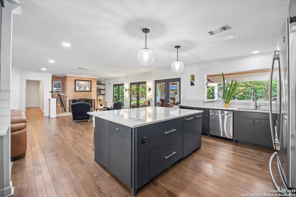 Fireplace, Interior, Kitchen, Pendant Lights, Recessed Lighting, Stainless Steel Appliances, Wood Texture Flooring