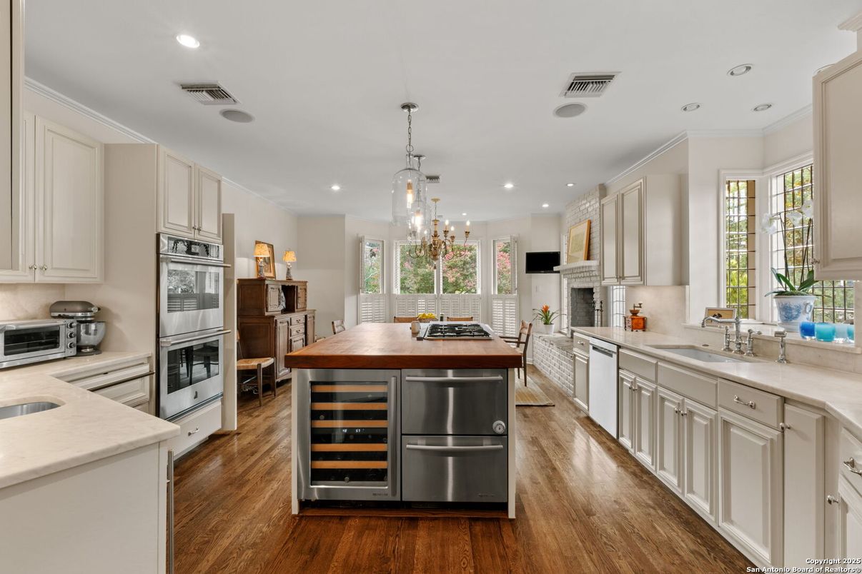 Chandelier, Fireplace, Interior, Kitchen, Pendant Lights, Recessed Lighting, Stainless Steel Appliances, Wood Texture Flooring