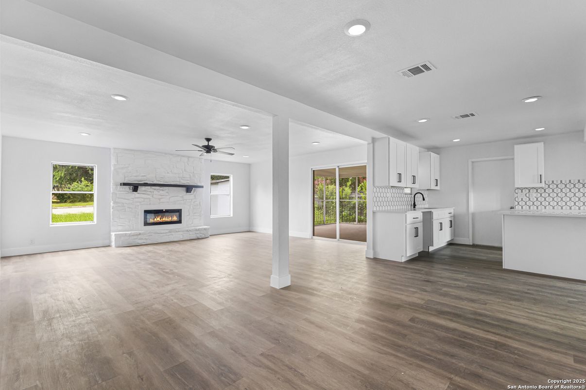 Empty room, Fireplace, Interior, Kitchen, Recessed Lighting, Washer, Wood Texture Flooring
