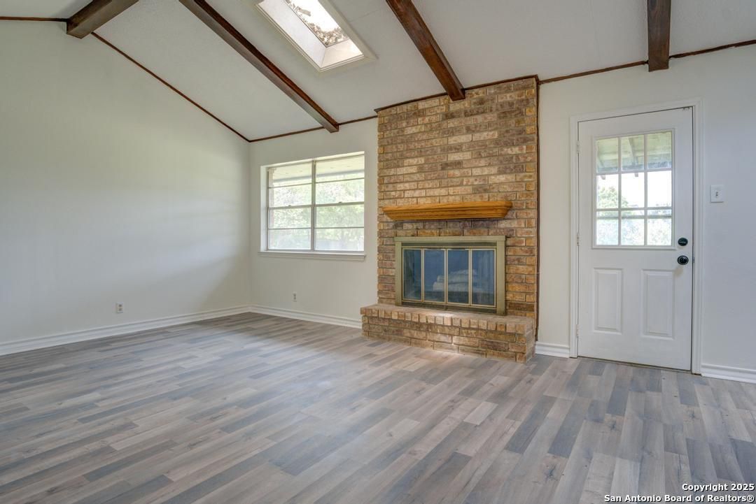 Empty room, Fireplace, Interior, Stone Walls, Wooden Beams, Wood Texture Flooring