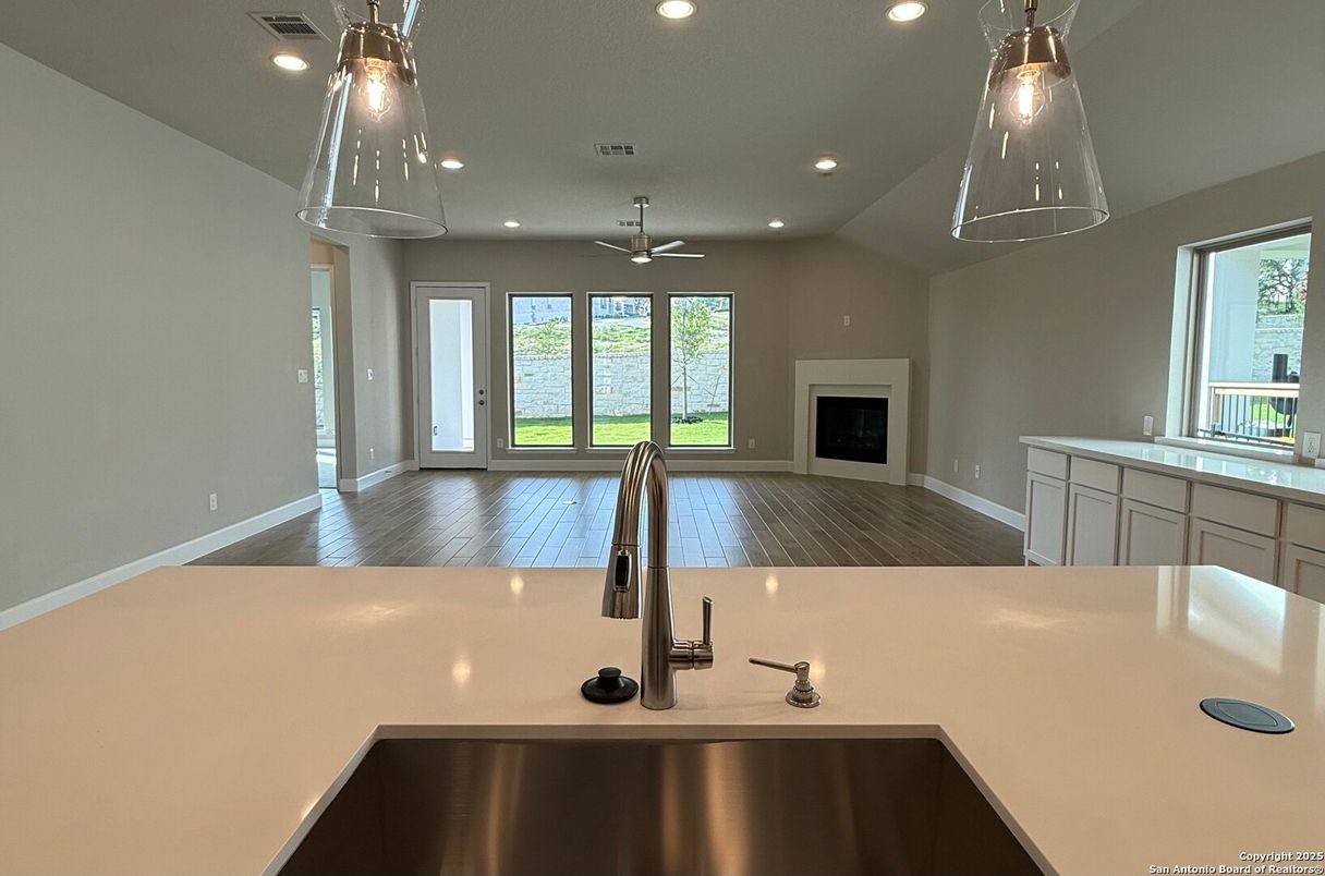 Empty room, Fireplace, Interior, Kitchen, Pendant Lights, Recessed Lighting, Wood Texture Flooring
