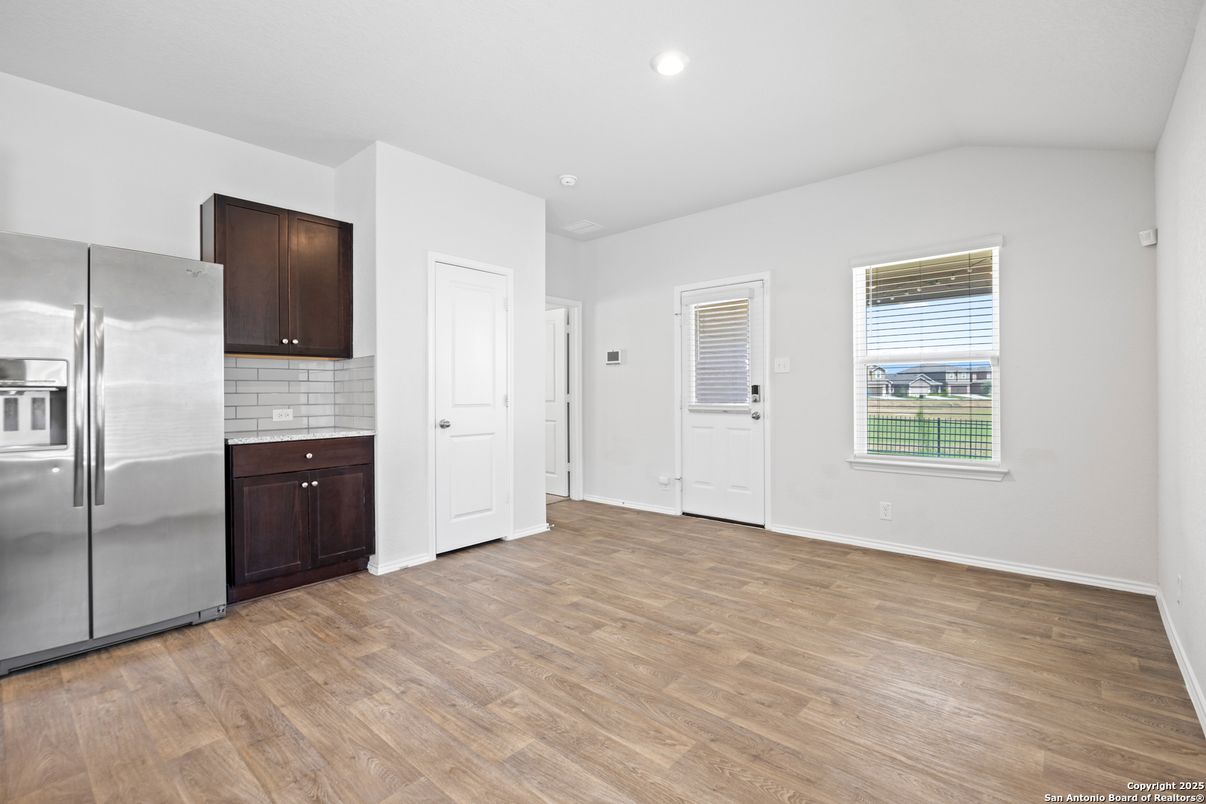 Empty room, Interior, Kitchen, Recessed Lighting, Stainless Steel Appliances, Wood Texture Flooring