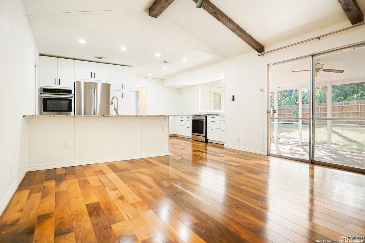 Empty room, Interior, Kitchen, Recessed Lighting, Stainless Steel Appliances, Wooden Beams, Wood Texture Flooring