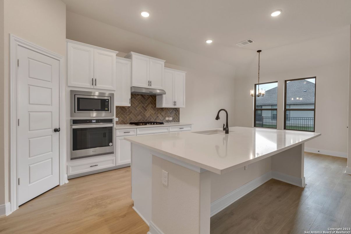 Chandelier, Interior, Kitchen, Pendant Lights, Recessed Lighting, Stainless Steel Appliances, Wood Texture Flooring