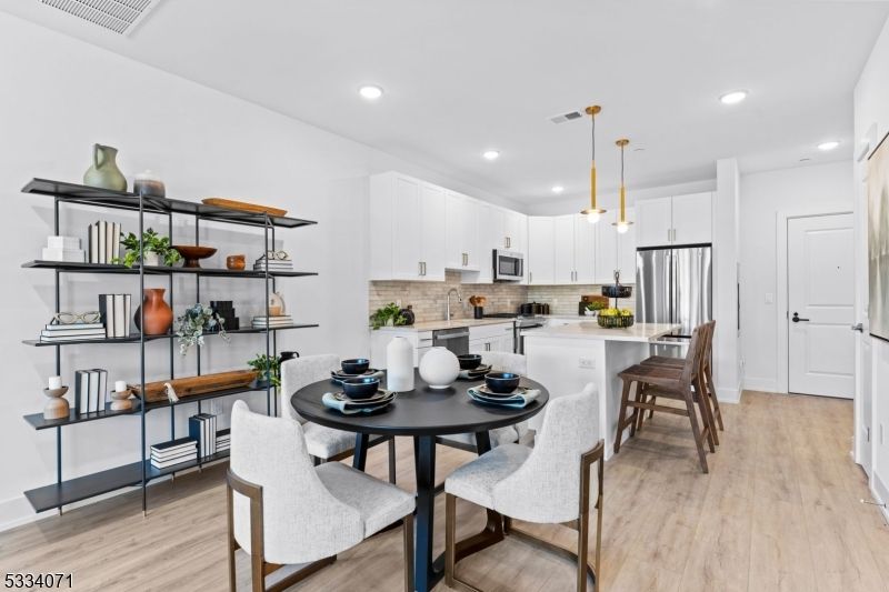 Dining room, Interior, Kitchen, Pendant Lights, Recessed Lighting, Stainless Steel Appliances, Wood Texture Flooring