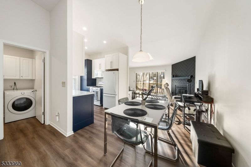 Dining room, Fireplace, Interior, Kitchen, Pendant Lights, Recessed Lighting, Utility Closets, Washer, Wood Texture Flooring