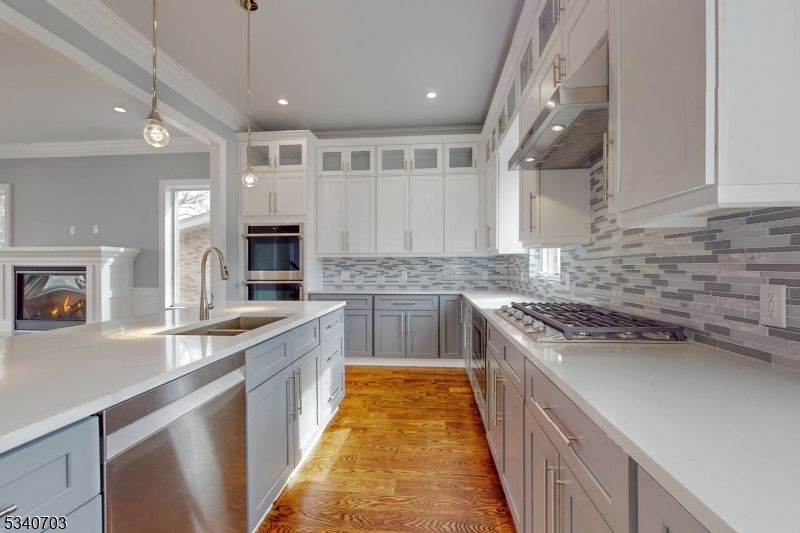 Fireplace, Interior, Kitchen, Pendant Lights, Recessed Lighting, Stainless Steel Appliances, Wood Texture Flooring