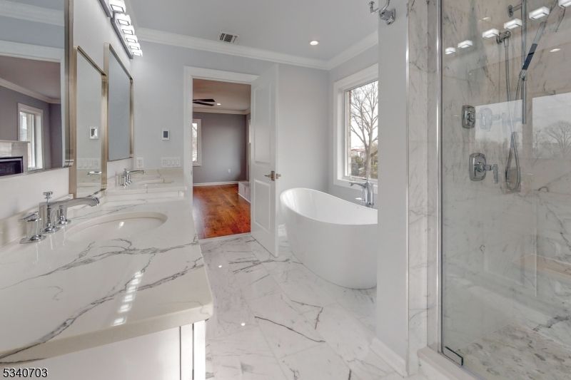 Bathroom, Dual Sink Vanities, Fireplace, Free Standing Baths, Glass Shower, Interior, Marble, Marble Walls, Recessed Lighting, Wood Texture Flooring