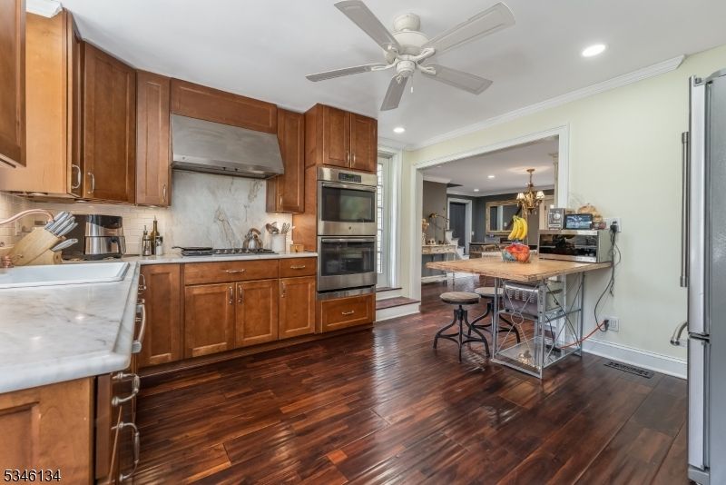Chandelier, Dining room, Interior, Kitchen, Recessed Lighting, Stainless Steel Appliances, Wood Texture Flooring
