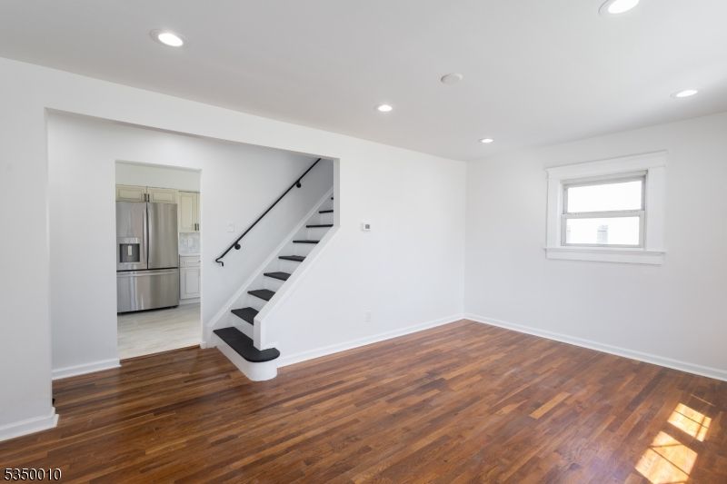Empty room, Interior, Kitchen, Recessed Lighting, Stainless Steel Appliances, Wood Texture Flooring