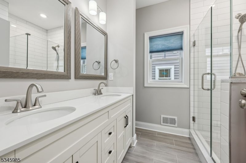 Bathroom, Dual Sink Vanities, Glass Shower, Interior, Recessed Lighting, Wood Texture Flooring