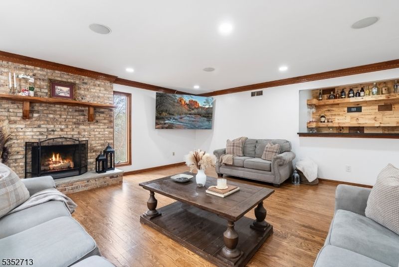 Fireplace, Interior, Living room, Recessed Lighting, Stone Walls, Wood Texture Flooring