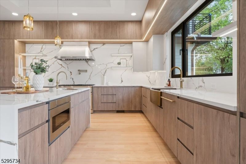 Interior, Kitchen, Marble Walls, Pendant Lights, Recessed Lighting, Stainless Steel Appliances, Wood Texture Flooring