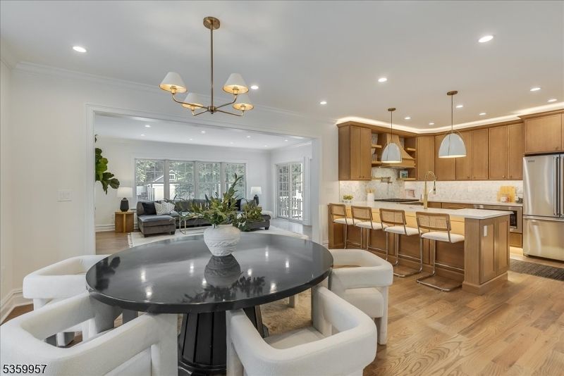 Chandelier, Dining room, Interior, Kitchen, Living room, Pendant Lights, Recessed Lighting, Stainless Steel Appliances, Wood Texture Flooring