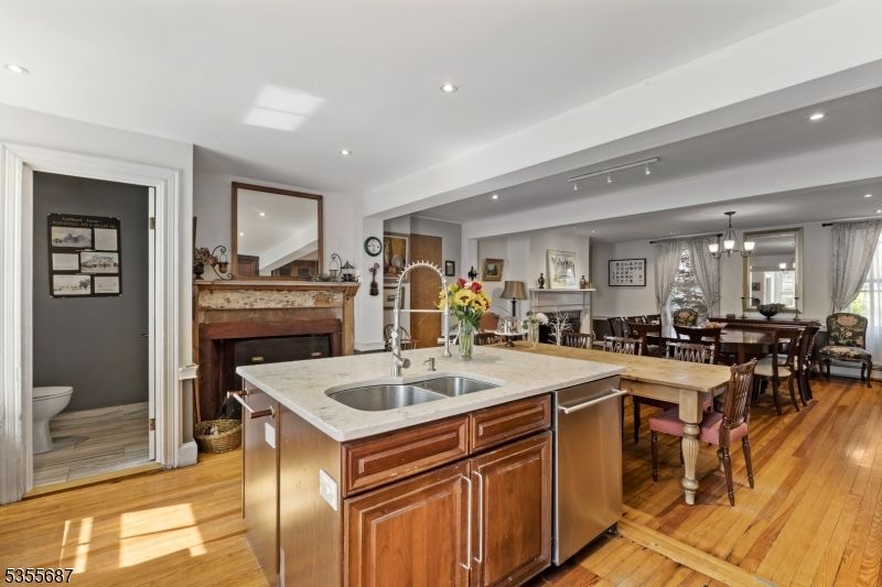 Dining room, Fireplace, Interior, Kitchen, Pendant Lights, Recessed Lighting, Stainless Steel Appliances, Wood Texture Flooring