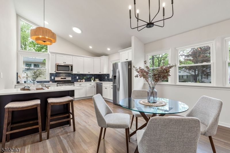 Chandelier, Dining room, Interior, Kitchen, Pendant Lights, Recessed Lighting, Stainless Steel Appliances, Wood Texture Flooring