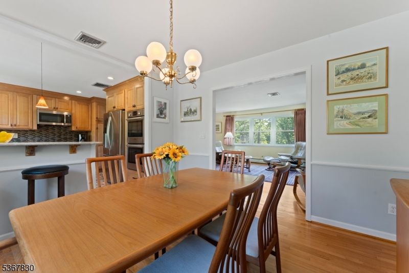 Chandelier, Dining room, Interior, Kitchen, Pendant Lights, Recessed Lighting, Stainless Steel Appliances, Wood Texture Flooring