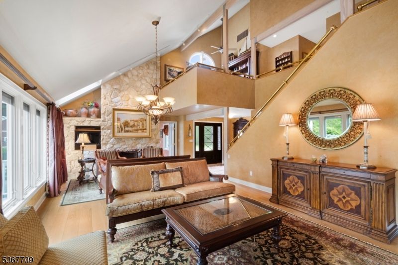 Chandelier, Dining room, Fireplace, Interior, Living room, Pendant Lights, Stone Walls, Wood Texture Flooring