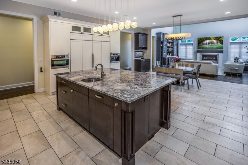 Chandelier, Dining room, Fireplace, Interior, Kitchen, Living room, Pendant Lights, Recessed Lighting, Stainless Steel Appliances