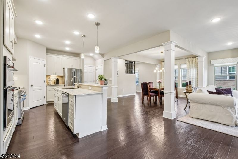 Chandelier, Dining room, Interior, Kitchen, Living room, Pendant Lights, Recessed Lighting, Stainless Steel Appliances, Wood Texture Flooring