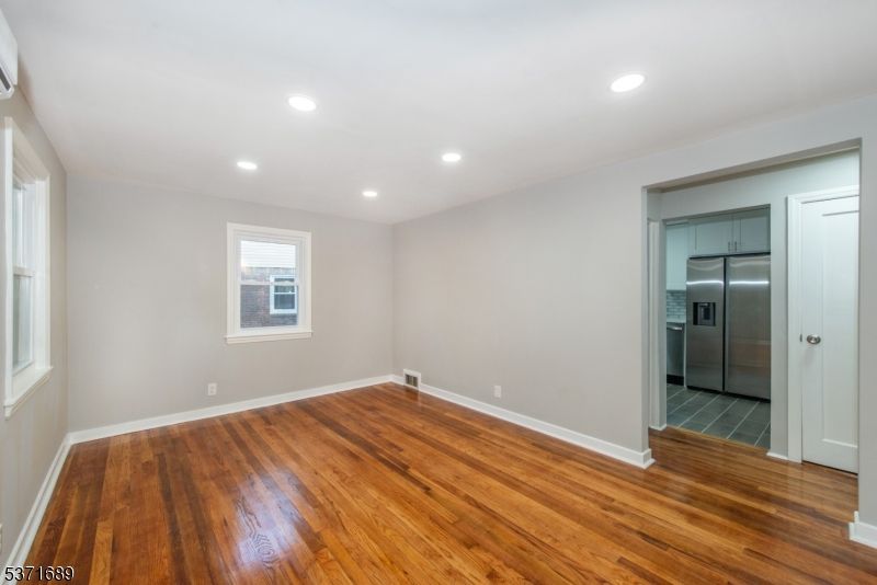 Empty room, Interior, Kitchen, Recessed Lighting, Stainless Steel Appliances, Wood Texture Flooring
