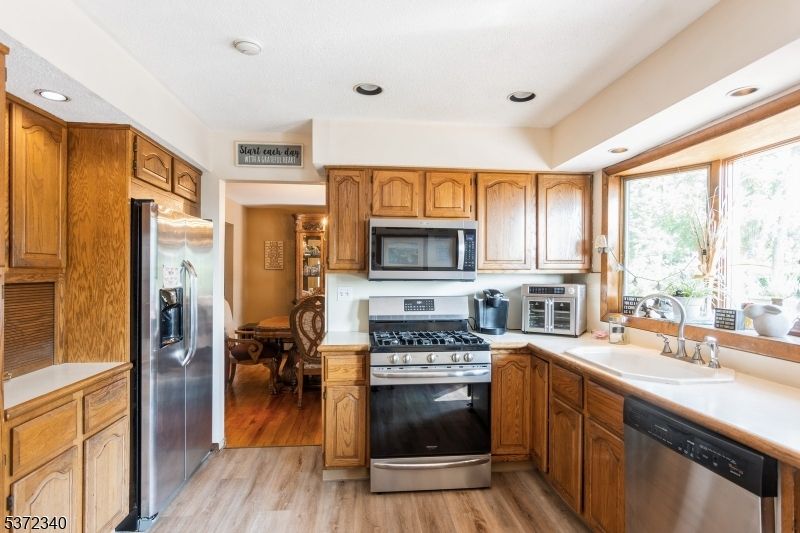 Dining room, Interior, Kitchen, Recessed Lighting, Stainless Steel Appliances, Wood Texture Flooring
