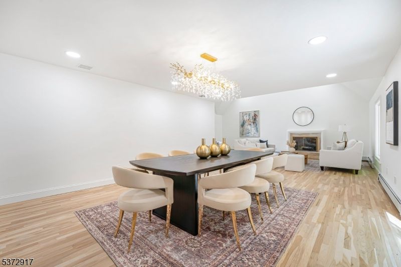 Chandelier, Dining room, Fireplace, Interior, Living room, Recessed Lighting, Wood Texture Flooring