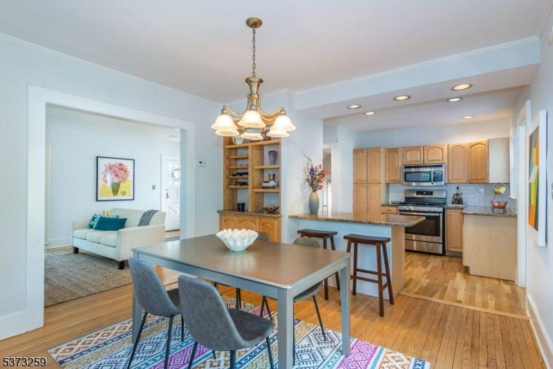 Chandelier, Dining room, Interior, Kitchen, Living room, Pendant Lights, Recessed Lighting, Stainless Steel Appliances, Wood Texture Flooring