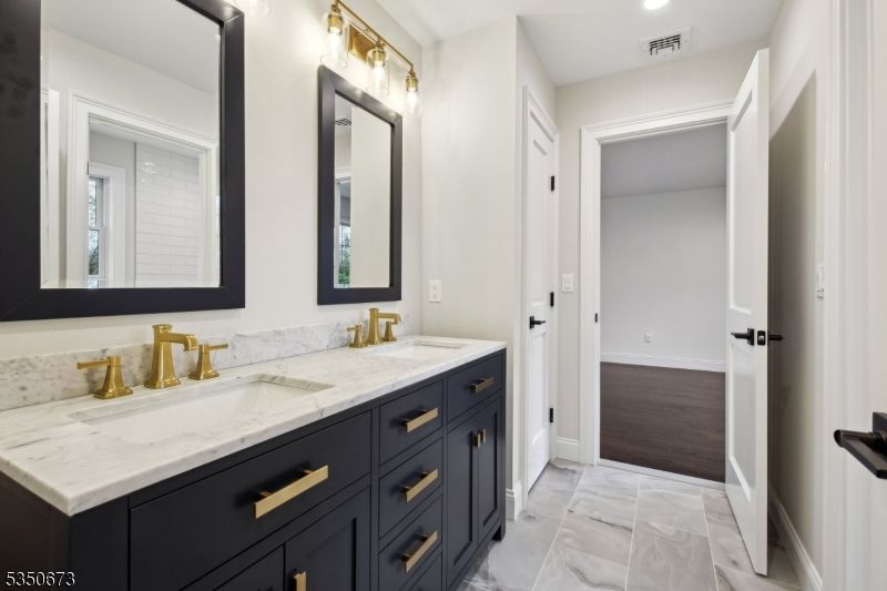 Bathroom, Dual Sink Vanities, Interior, Marble, Recessed Lighting, Wood Texture Flooring