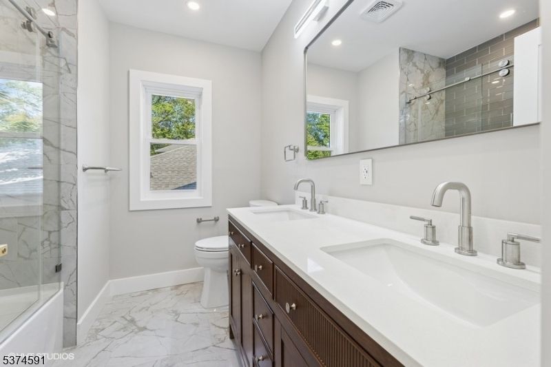 Bathroom, Dual Sink Vanities, Glass Shower, Interior, Marble, Marble Walls, Recessed Lighting