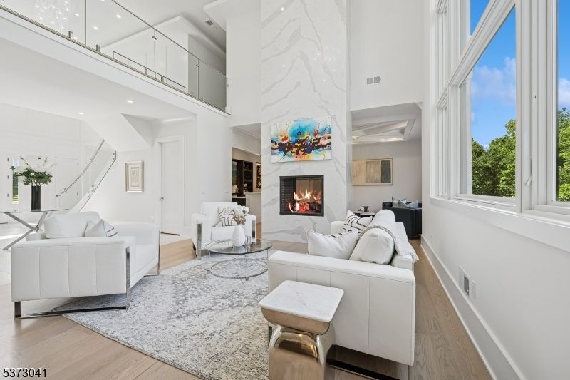 Fireplace, Interior, Living room, Marble Walls, Recessed Lighting, Wood Texture Flooring