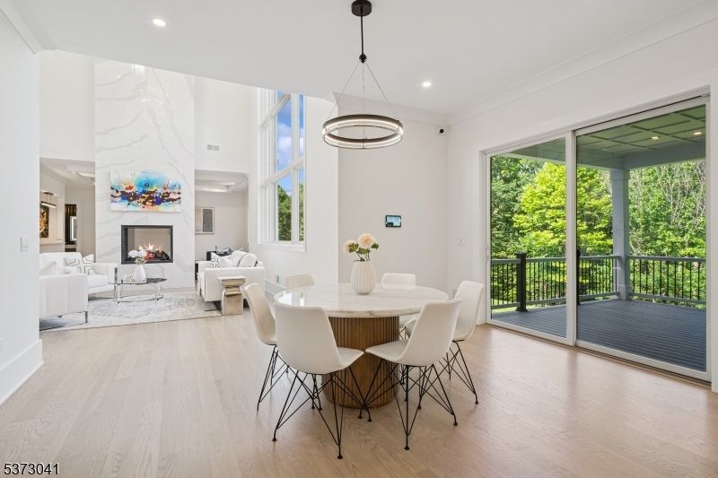 Dining room, Fireplace, Interior, Living room, Marble Walls, Pendant Lights, Recessed Lighting, Wood Texture Flooring