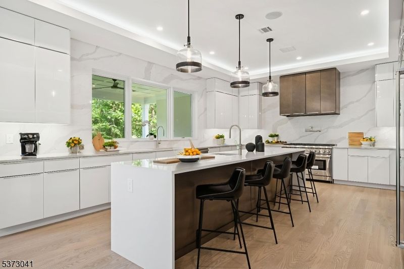 Interior, Kitchen, Marble Walls, Pendant Lights, Recessed Lighting, Stainless Steel Appliances, Wood Texture Flooring