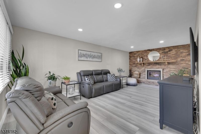Fireplace, Interior, Living room, Recessed Lighting, Stone Walls, Wood Texture Flooring