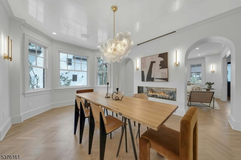 Chandelier, Dining room, Fireplace, Interior, Living room, Pendant Lights, Recessed Lighting, Wood Texture Flooring