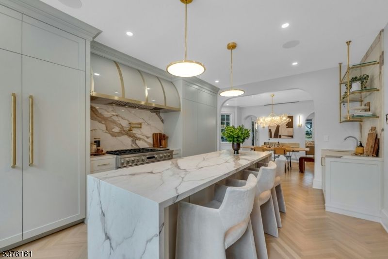 Chandelier, Dining room, Interior, Kitchen, Marble Walls, Pendant Lights, Recessed Lighting, Stainless Steel Appliances, Wood Texture Flooring