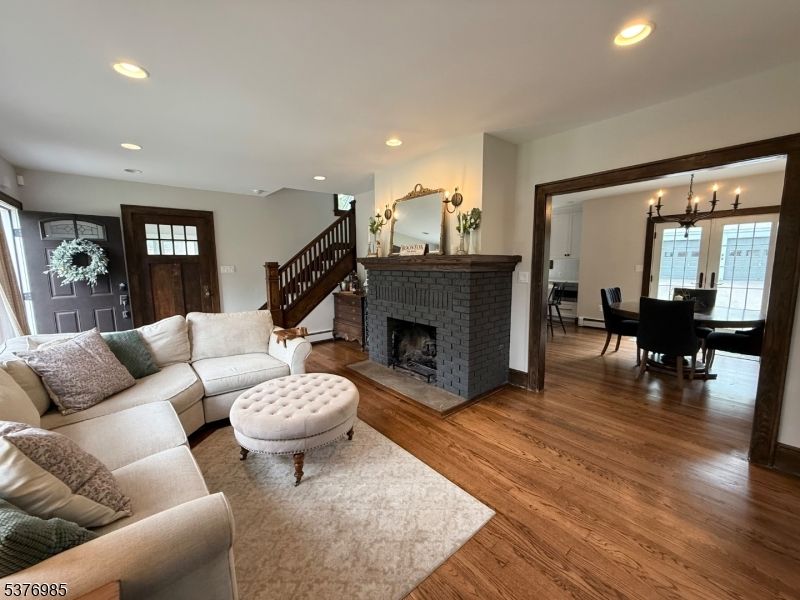 Chandelier, Dining room, Fireplace, Interior, Living room, Recessed Lighting, Wood Texture Flooring