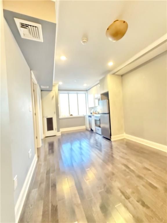 Empty room, Interior, Kitchen, Pendant Lights, Recessed Lighting, Stainless Steel Appliances, Wood Texture Flooring