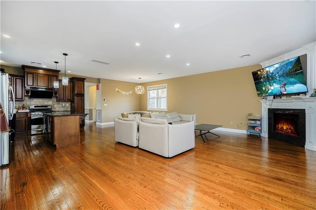 Fireplace, Interior, Kitchen, Living room, Pendant Lights, Recessed Lighting, Stainless Steel Appliances, Wood Texture Flooring