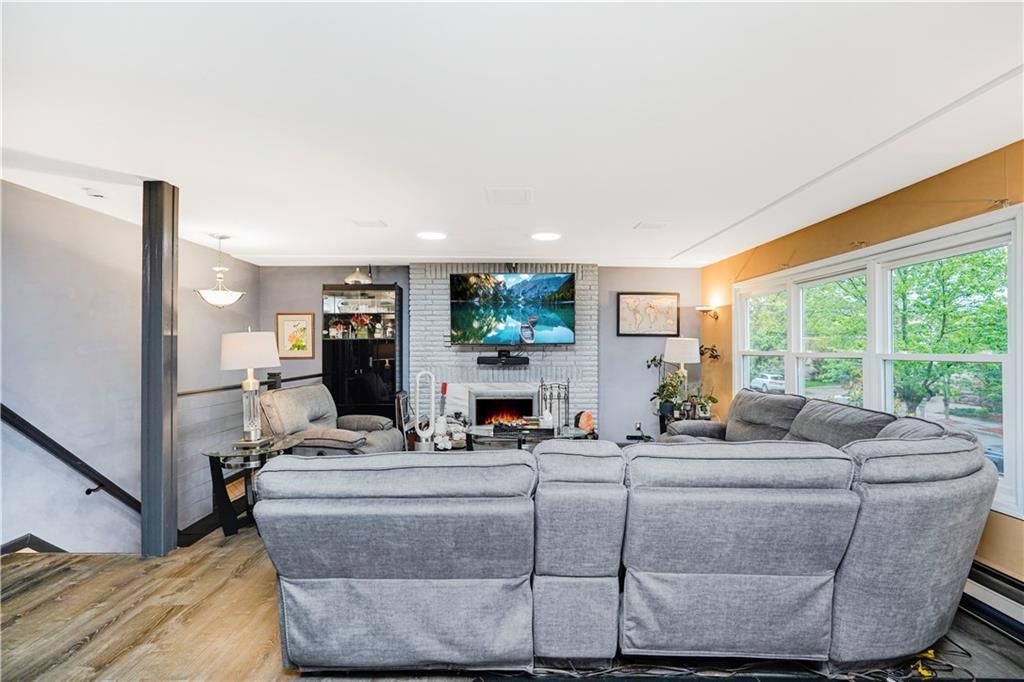 Fireplace, Interior, Living room, Pendant Lights, Recessed Lighting, Stone Walls, Wood Texture Flooring