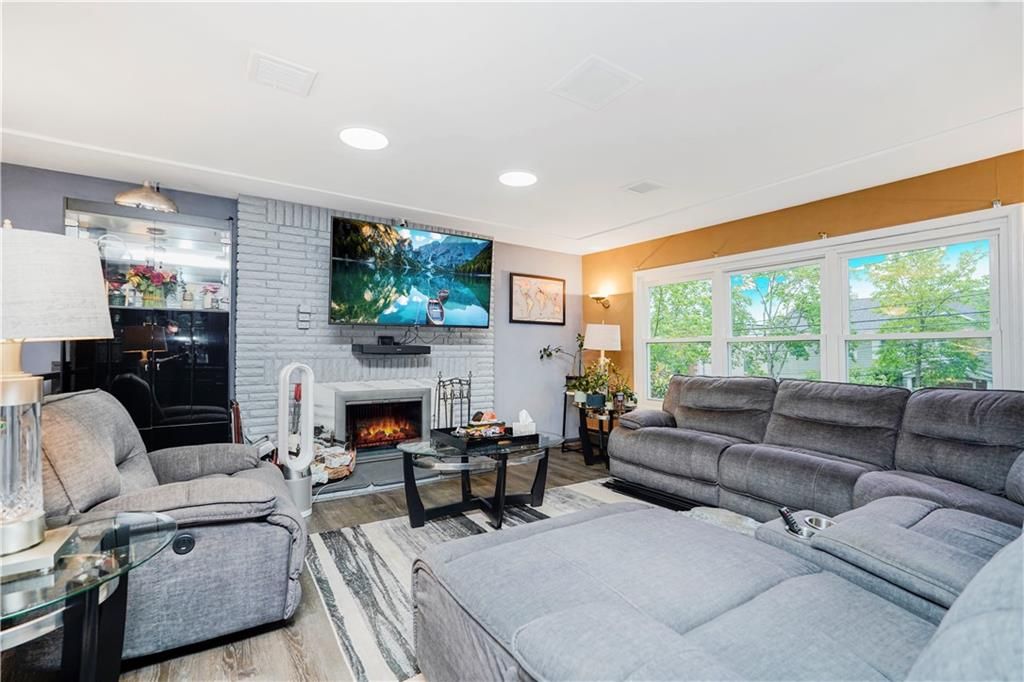 Fireplace, Interior, Living room, Recessed Lighting, Stone Walls, Wood Texture Flooring