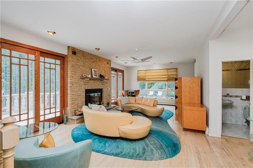 Fireplace, Interior, Living room, Recessed Lighting, Stone Walls, Wood Texture Flooring