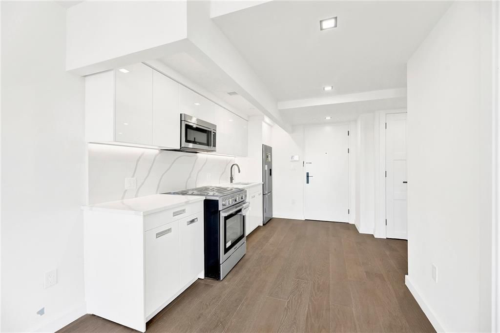 Interior, Kitchen, Marble Walls, Recessed Lighting, Stainless Steel Appliances, Wood Texture Flooring