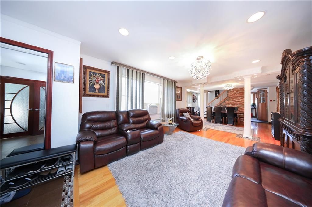 Chandelier, Fireplace, Interior, Living room, Recessed Lighting, Stone Walls, Wood Texture Flooring