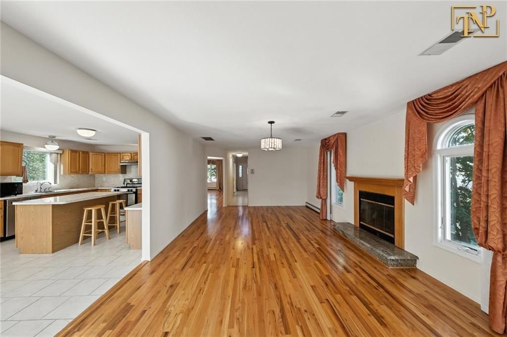 Chandelier, Fireplace, Interior, Kitchen, Pendant Lights, Stainless Steel Appliances, Wood Texture Flooring